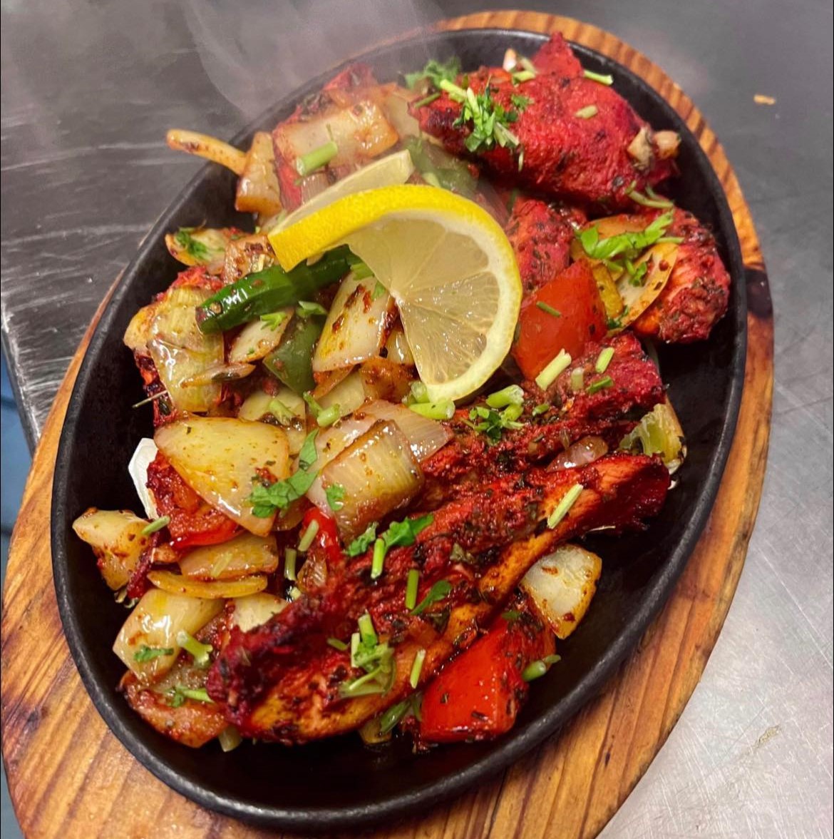 Chicken tikka masala with fresh sides Served at Wee Sunny’s in Dundee